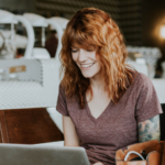 Woman reading a laptop in a cafe